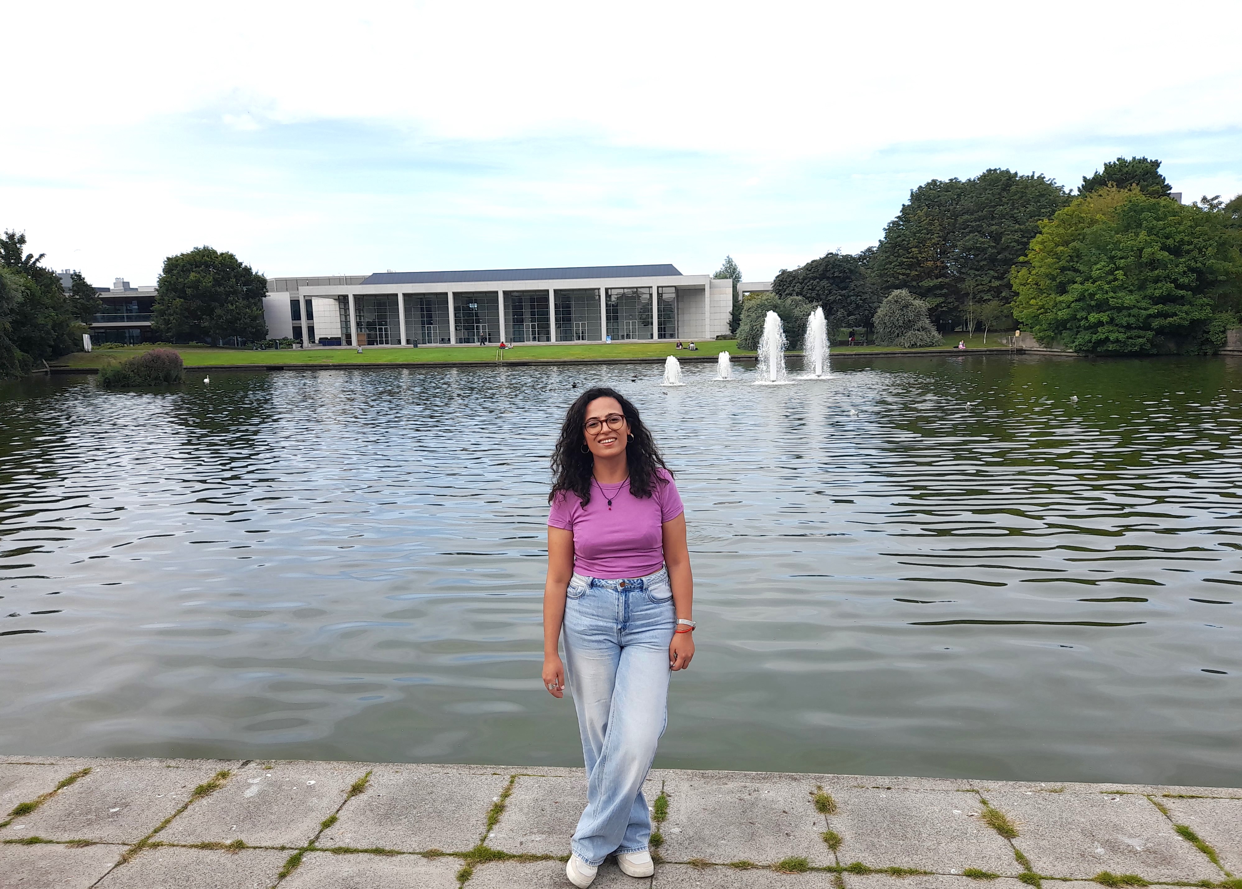 A student standing in front of UCD lake.